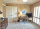 Bedroom with neutral carpet, wood paneled walls, and window with shutters at 1118 E Orangewood Ave, Phoenix, AZ 85020