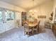 Formal dining room featuring a chandelier, seating for six, and double door access to the home's exterior at 1118 E Orangewood Ave, Phoenix, AZ 85020