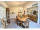 Traditional dining room with seating for six and classic chandelier, complemented by a decorative cabinet at 1118 E Orangewood Ave, Phoenix, AZ 85020