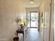Inviting entryway featuring neutral wallpaper, tiled floor, and views of the home's exterior through the front door at 1118 E Orangewood Ave, Phoenix, AZ 85020