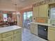 Bright eat-in kitchen featuring neutral cabinets, black dishwasher, tile floors, and sliding glass door at 1118 E Orangewood Ave, Phoenix, AZ 85020