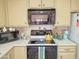 Charming kitchen features a black oven, microwave and cabinets with decorative countertop details at 1118 E Orangewood Ave, Phoenix, AZ 85020
