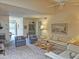 Open-concept living room with plush carpeting, comfortable seating, and decorative touches throughout the space at 1118 E Orangewood Ave, Phoenix, AZ 85020