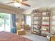 Airy main bedroom with decorative shelf, access to the yard, and cozy lounge area at 1118 E Orangewood Ave, Phoenix, AZ 85020