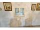 Close-up of a white wall with an internal shuttered window surrounded by framed pictures at 1118 E Orangewood Ave, Phoenix, AZ 85020