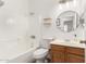 Full bathroom with tub-shower combination, round mirror, and wood vanity at 11182 W Coronado Rd, Avondale, AZ 85392