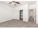 Bright bedroom with ceiling fan and closet with shelving at 11182 W Coronado Rd, Avondale, AZ 85392