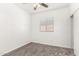 This cozy bedroom features neutral carpet, a ceiling fan, and a window for natural light at 11182 W Coronado Rd, Avondale, AZ 85392
