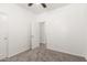 Bright bedroom with neutral carpet, a ceiling fan, and a spacious closet at 11182 W Coronado Rd, Avondale, AZ 85392