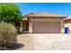 Charming single-Gathering home showing a two-car garage, desert landscaping, and tile roof at 11182 W Coronado Rd, Avondale, AZ 85392