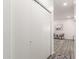 Hallway with wood-style flooring, coat closet, and cozy sitting area ahead at 11182 W Coronado Rd, Avondale, AZ 85392