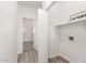 Laundry room with open door and signage, vinyl plank floor, and appliance hookups at 11182 W Coronado Rd, Avondale, AZ 85392