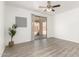 Bright living room with sliding glass doors and modern ceiling fan fixture at 11182 W Coronado Rd, Avondale, AZ 85392
