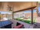 This backyard has a covered patio seating area, a fire pit, a pool with a pergola and privacy fencing at 11252 E Edgewood Ave, Mesa, AZ 85208