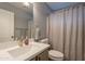 Updated bathroom features a modern vanity, framed mirror, and shower with stylish curtain at 11252 E Edgewood Ave, Mesa, AZ 85208