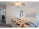 Cozy bedroom with ceiling fan, bright natural light, and closet access at 11252 E Edgewood Ave, Mesa, AZ 85208