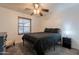 Comfortable bedroom with carpet flooring, a ceiling fan, and a large window at 11252 E Edgewood Ave, Mesa, AZ 85208