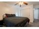 Spacious bedroom with carpet flooring, ceiling fan, closet access, and an ensuite at 11252 E Edgewood Ave, Mesa, AZ 85208