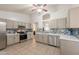 Bright kitchen with tile floors, stainless steel appliances, light cabinets, and stunning backsplash at 11252 E Edgewood Ave, Mesa, AZ 85208