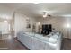 Comfortable living room with wood floors, a large couch, and a view into the kitchen at 11252 E Edgewood Ave, Mesa, AZ 85208