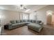 Spacious living room features a skylight, ceiling fan, and large sectional couch, perfect for relaxing at 11252 E Edgewood Ave, Mesa, AZ 85208