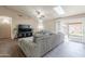 Cozy living room with a large couch, skylight, and sliding glass door that provides natural light at 11252 E Edgewood Ave, Mesa, AZ 85208