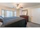 Well-lit bedroom features a ceiling fan, a bay window, and a wooden dresser at 11252 E Edgewood Ave, Mesa, AZ 85208