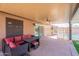 Outdoor seating under covered patio next to pool and backyard area at 11252 E Edgewood Ave, Mesa, AZ 85208