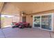 Covered patio with outdoor seating, grill, and view of the backyard at 11252 E Edgewood Ave, Mesa, AZ 85208