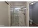 Bright bathroom showcasing a sleek glass-enclosed shower with modern fixtures at 11252 E Edgewood Ave, Mesa, AZ 85208