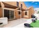 Outdoor patio with shade coverings, planters and sliding glass doors for indoor/outdoor living at 1134 S Lydia Ln, Gilbert, AZ 85296