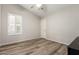 Neutral bedroom featuring wood-look floors, a ceiling fan, and window shutters at 1134 S Lydia Ln, Gilbert, AZ 85296