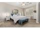 Bright bedroom featuring neutral walls, a ceiling fan, and a well-lit window with modern shutters at 1134 S Lydia Ln, Gilbert, AZ 85296