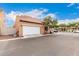 Home exterior with neutral stucco, tile roof and white garage door at 1134 S Lydia Ln, Gilbert, AZ 85296
