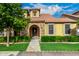 Charming home featuring a stone archway, lush green lawn and well-manicured hedges at 1134 S Lydia Ln, Gilbert, AZ 85296