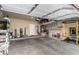 Spacious two car garage with storage, shelving, and equipment at 1134 S Lydia Ln, Gilbert, AZ 85296