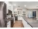 Modern kitchen with stainless steel appliances, white cabinets, and stylish backsplash at 1134 S Lydia Ln, Gilbert, AZ 85296