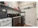 Laundry room with washer, dryer, shelving, and rod at 1134 S Lydia Ln, Gilbert, AZ 85296