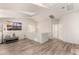 Bright living space with skylight, art, and modern gray wood-look flooring at 1134 S Lydia Ln, Gilbert, AZ 85296