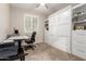 Bright home office featuring white built-ins, a Murphy bed, a modern desk, and natural light at 1134 S Lydia Ln, Gilbert, AZ 85296