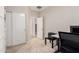 Home office area with sliding doors, neutral walls, and access to other areas of the home at 1134 S Lydia Ln, Gilbert, AZ 85296