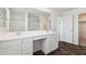 Bright bathroom featuring double sinks, a large mirror, and dark flooring at 12531 W Glenn Dr, Glendale, AZ 85307
