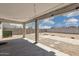 View of covered patio with concrete columns overlooking a large backyard with decorative rock at 12531 W Glenn Dr, Glendale, AZ 85307