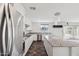 Modern kitchen with stainless appliances, granite countertops, and large island open to living area at 12531 W Glenn Dr, Glendale, AZ 85307