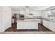 Stylish kitchen features white cabinetry, stainless steel appliances, and a granite countertop island at 12531 W Glenn Dr, Glendale, AZ 85307