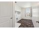 Well-lit laundry room featuring tile floors, ample shelving, and a utility sink at 12531 W Glenn Dr, Glendale, AZ 85307