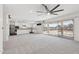 Open-concept living space flows into the kitchen and out to the patio through sliding glass doors at 12531 W Glenn Dr, Glendale, AZ 85307