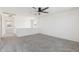 Spacious loft area with neutral carpet, ceiling fan, and access to other rooms at 12531 W Glenn Dr, Glendale, AZ 85307
