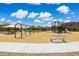 Community playground with swings, slides, and a shaded picnic area on a sunny day at 12531 W Glenn Dr, Glendale, AZ 85307