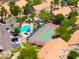 Overhead angle showcasing the community pool, tennis court, verdant landscaping, and assigned parking of the complex at 1287 N Alma School Rd # 171, Chandler, AZ 85224